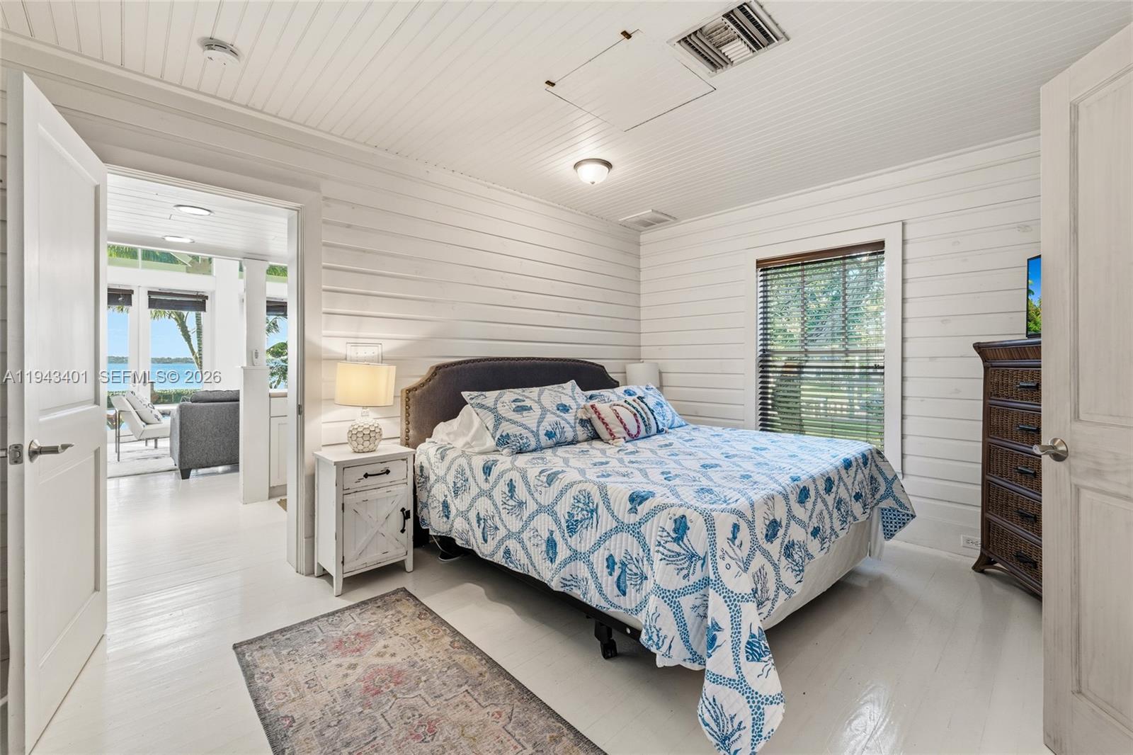 1890 Northwest River Trail Stuart, FL 34994 - Photo 38 of 52 a bed sitting in a spacious bedroom next to a window