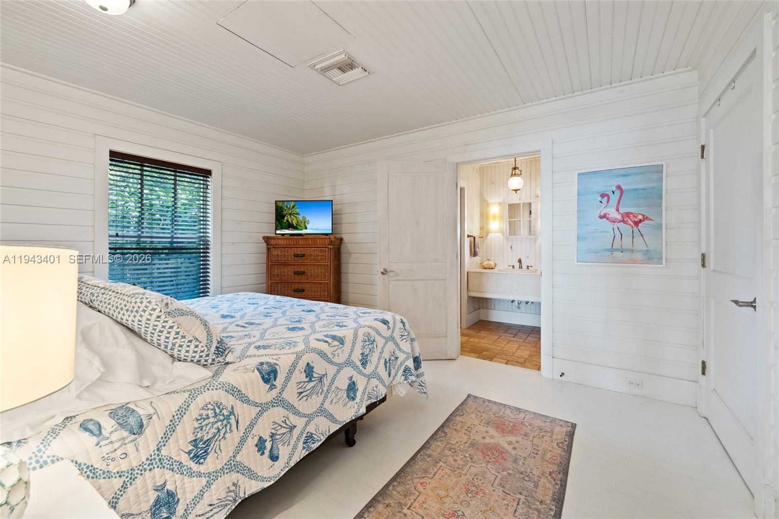 1890 Northwest River Trail Stuart, FL 34994 - Photo 39 of 52 a bedroom with a large bed and a walk in closet