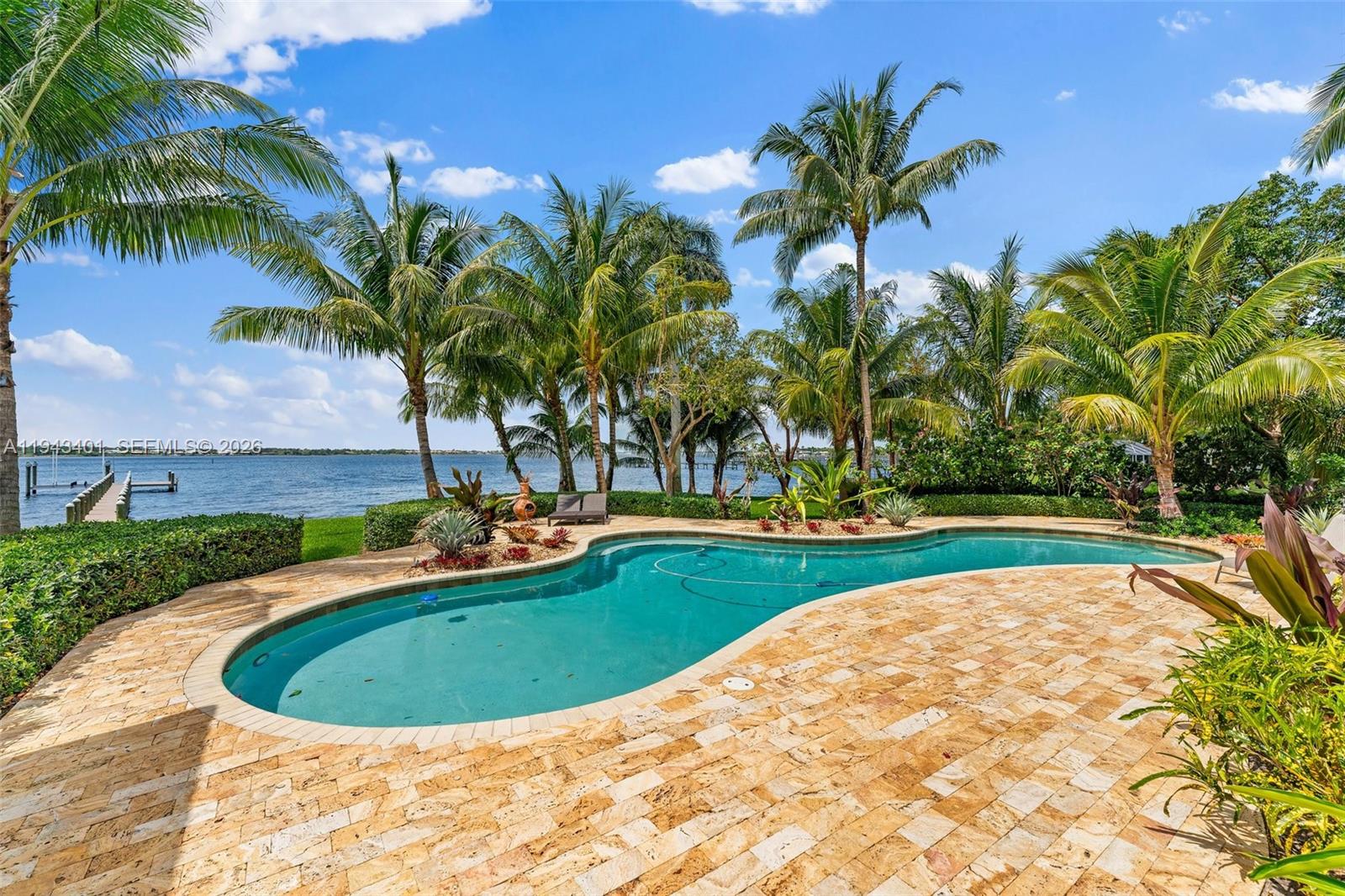 1890 Northwest River Trail Stuart, FL 34994 - Photo 42 of 52 a view of a swimming pool with a yard and palm trees