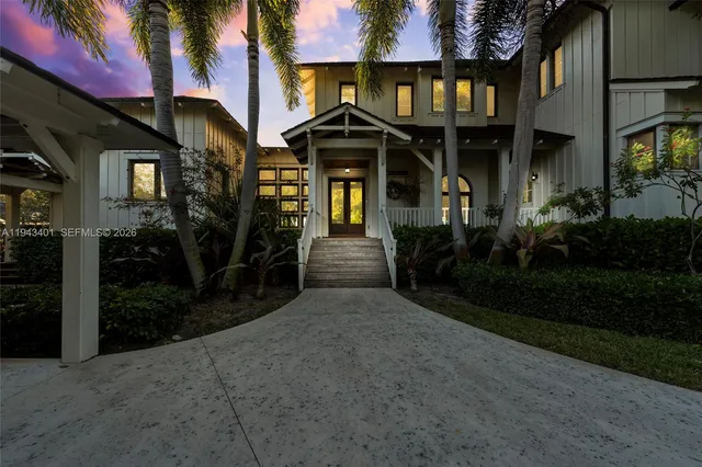 a view of a big house with a big yard and potted plants