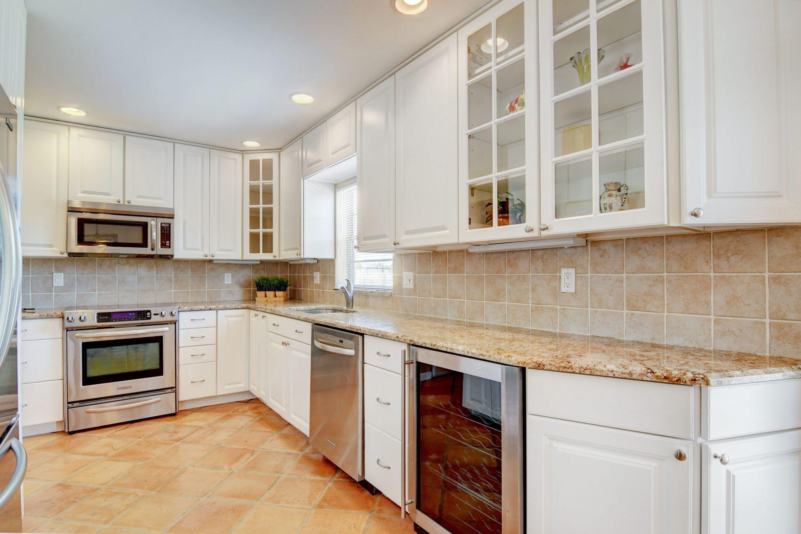 9989 Liberty Road Boca Raton, FL 33434 - Photo 4 of 44 a kitchen with stainless steel appliances granite countertop a stove and a sink