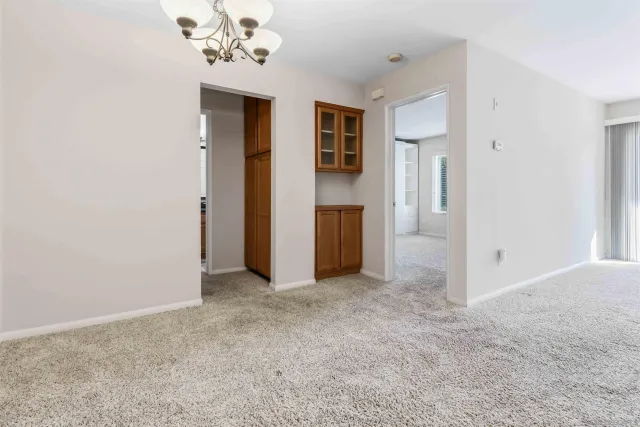 an empty room with windows and closet