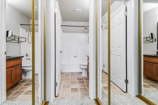 a bathroom with a shower and a glass door