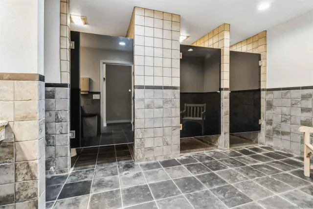 a bathroom with a shower and a mirror