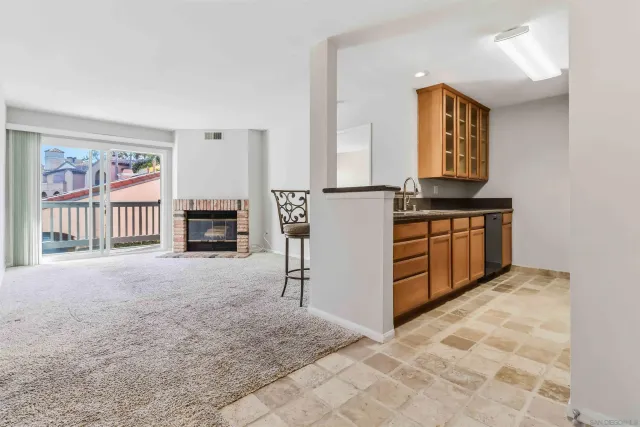 a view of kitchen with furniture and a refrigerator