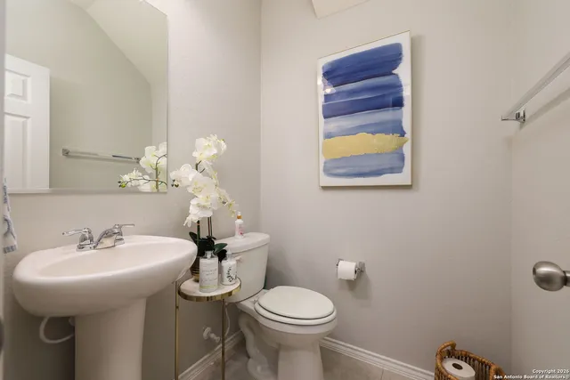 a bathroom with a sink mirror and toilet
