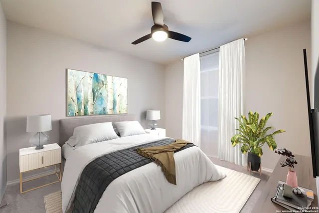 a bedroom with a large bed and a potted plant