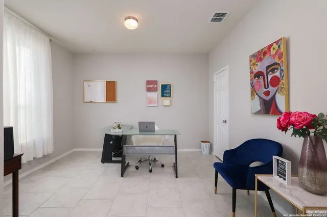 a living room with furniture and a potted plant