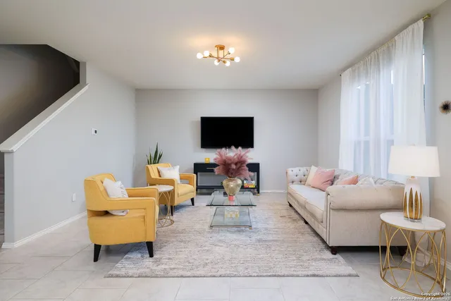 a living room with furniture and a flat screen tv