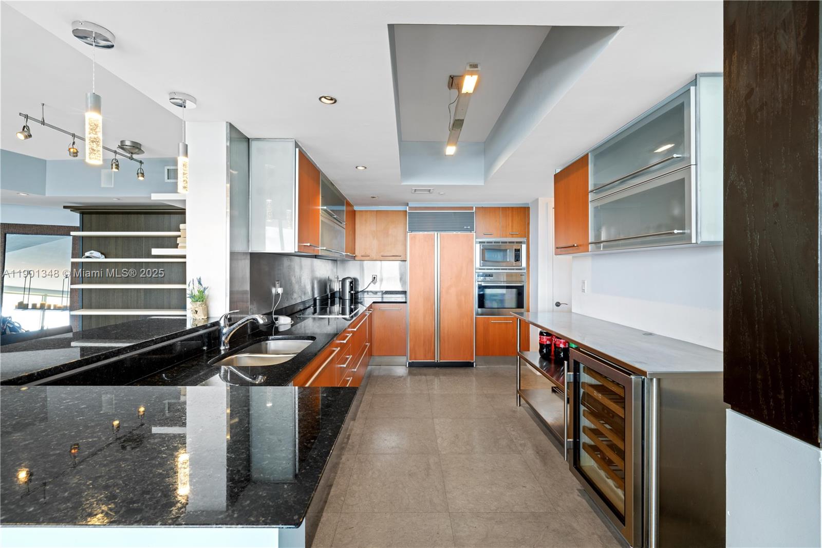 400 Alton Road, Unit 3006 Miami Beach, FL 33139 - Photo 11 of 28 a kitchen with stainless steel appliances a stove a sink and a refrigerator