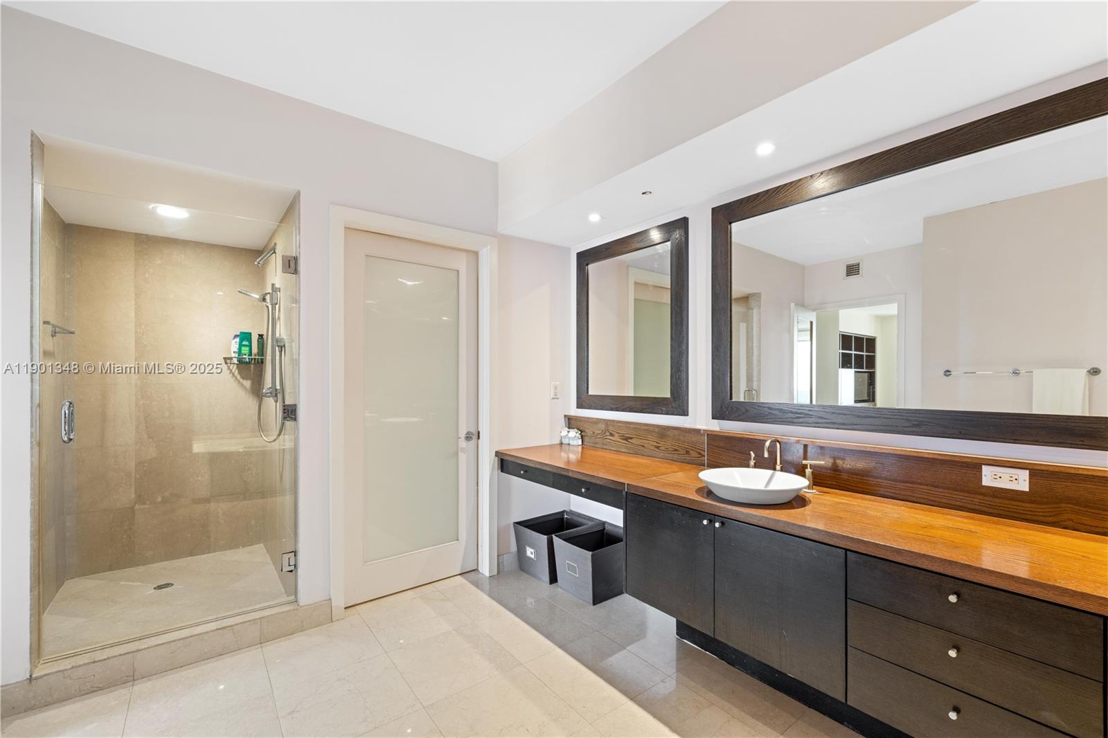 400 Alton Road, Unit 3006 Miami Beach, FL 33139 - Photo 16 of 28 a spacious bathroom with a shower a sink and a mirror