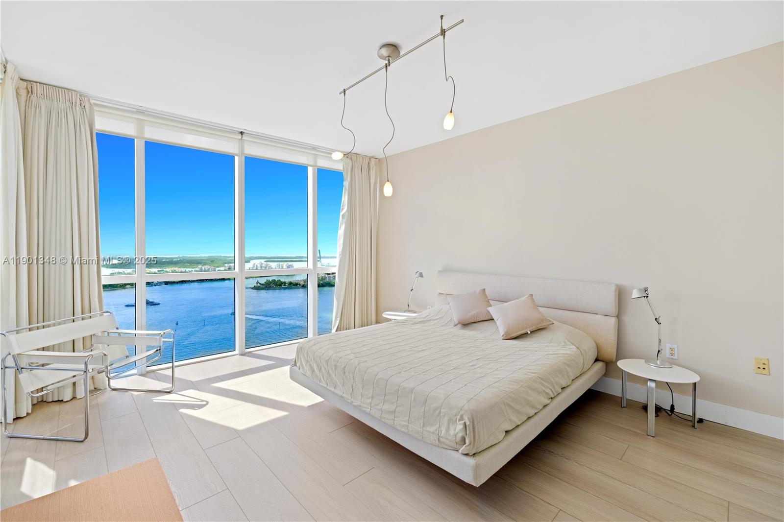 400 Alton Road, Unit 3006 Miami Beach, FL 33139 - Photo 19 of 28 a bedroom with a bed a table and chair