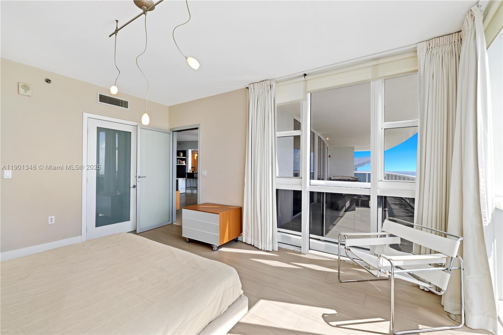 400 Alton Road, Unit 3006 Miami Beach, FL 33139 - Photo 20 of 28 a bedroom with furniture and window