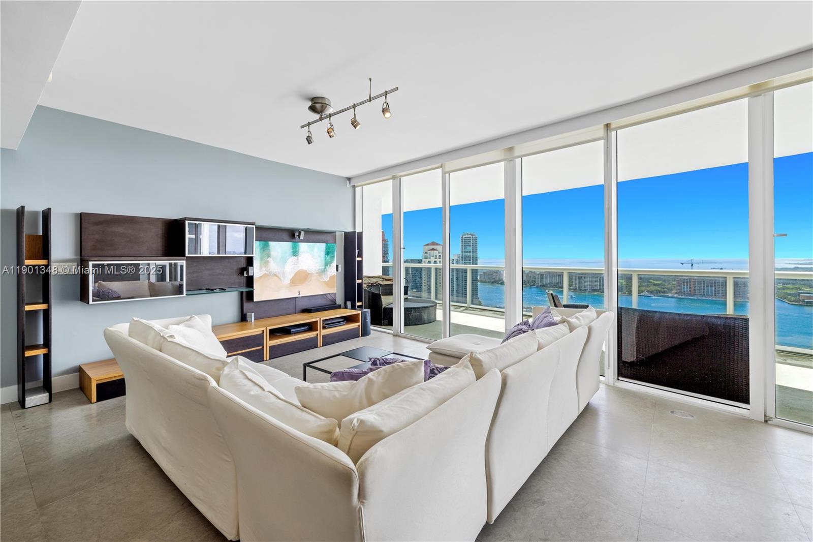 400 Alton Road, Unit 3006 Miami Beach, FL 33139 - Photo 2 of 28 a living room with furniture and a flat screen tv
