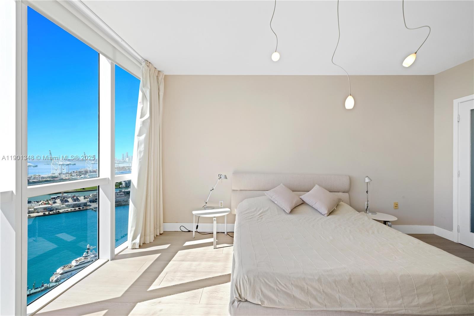 400 Alton Road, Unit 3006 Miami Beach, FL 33139 - Photo 21 of 28 a bedroom with a bed and a night stand