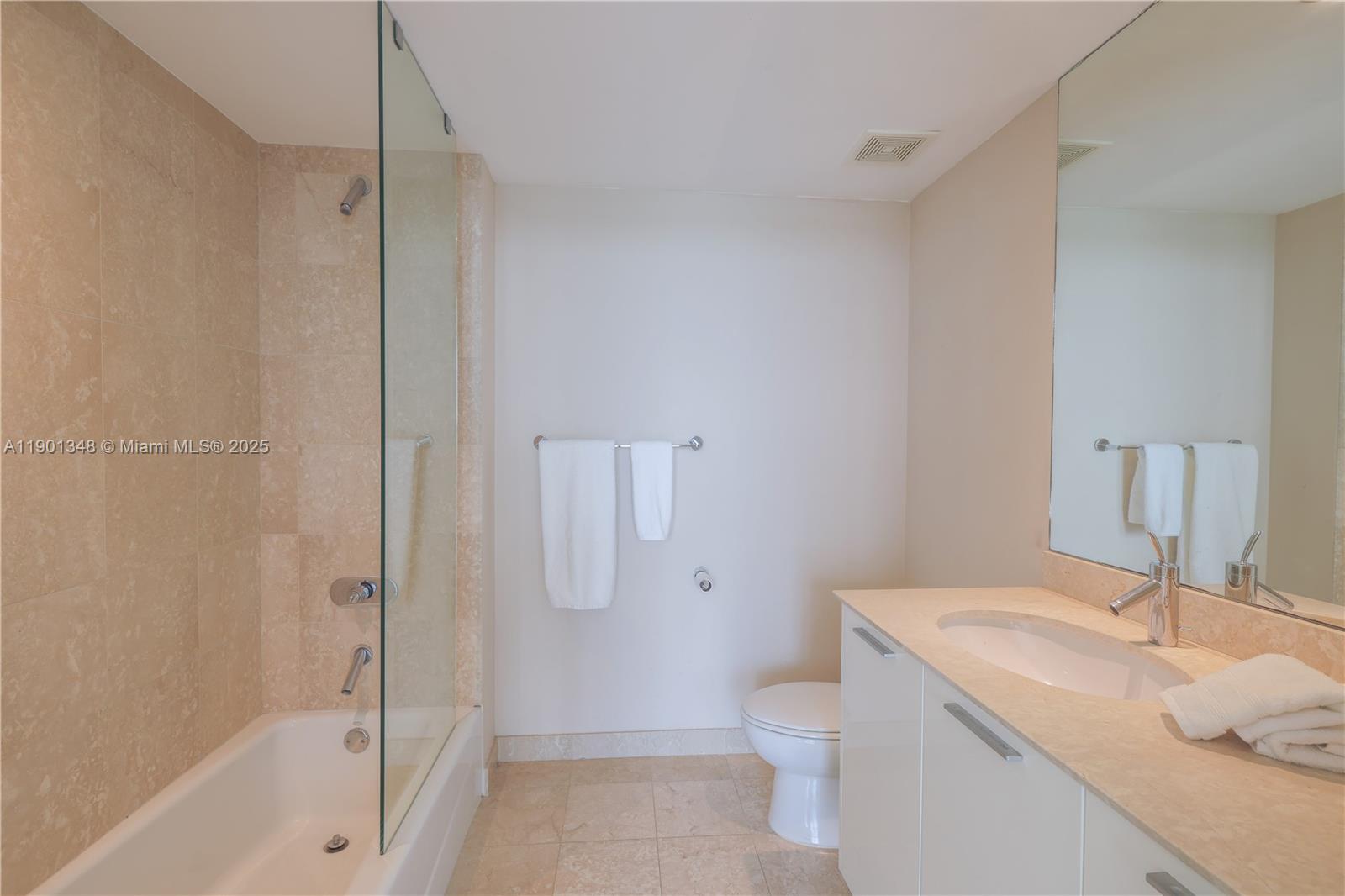 400 Alton Road, Unit 3006 Miami Beach, FL 33139 - Photo 22 of 28 a bathroom with a sink toilet and shower