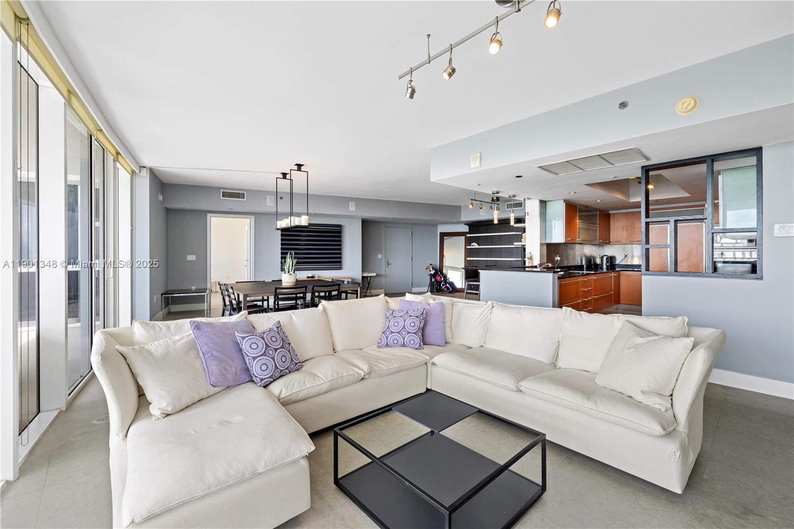 400 Alton Road, Unit 3006 Miami Beach, FL 33139 - Photo 7 of 28 a living room with furniture kitchen view and a chandelier