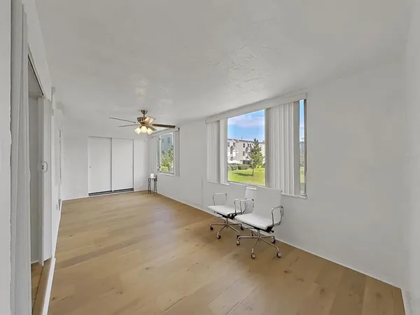a view of an empty room with a ceiling fan