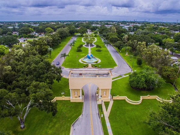 an aerial view of a house with a yard and lake view