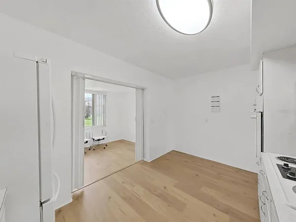 a kitchen with white cabinets and white appliances