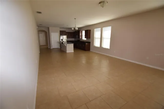 a view of empty room with fireplace and windows