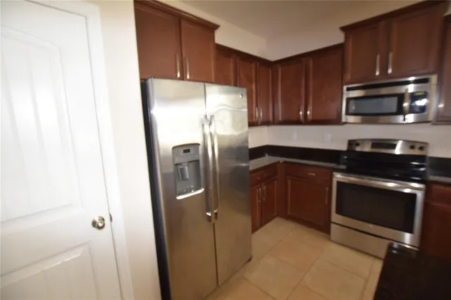 a kitchen with stainless steel appliances granite countertop a refrigerator stove a sink and dishwasher