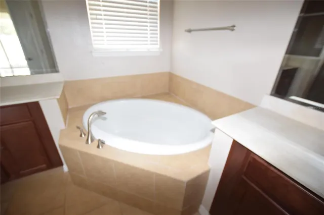 a bathroom with a bathtub and a window