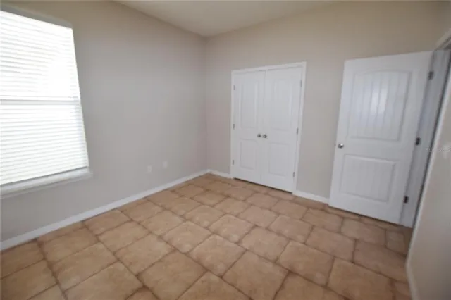 a view of a room with white paint and a window