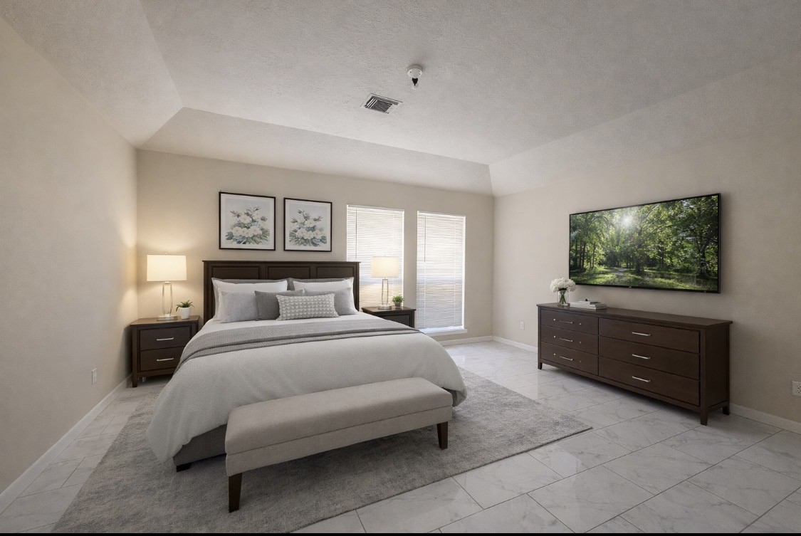 11227 Agave Ridge Lane Houston, TX 77089 - Photo 5 of 10 a bedroom with a bed and a flat screen tv