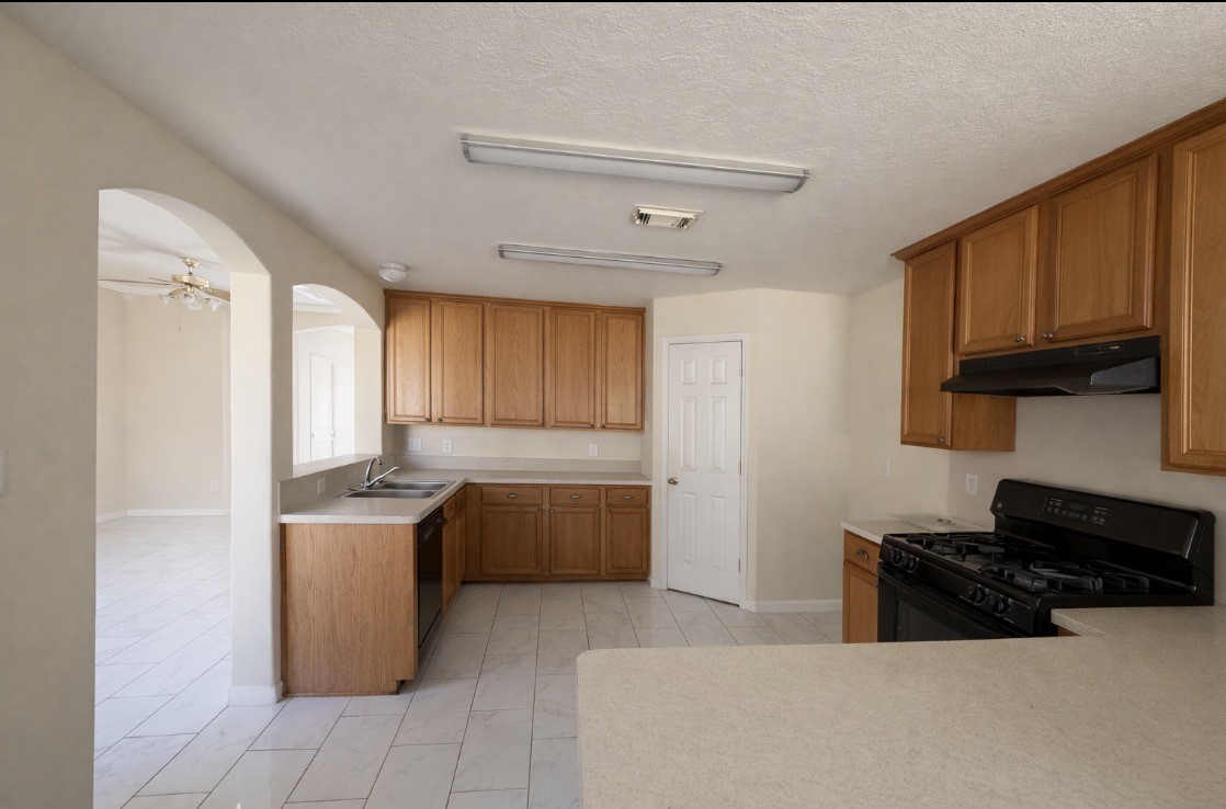 11227 Agave Ridge Lane Houston, TX 77089 - Photo 7 of 10 a kitchen with stainless steel appliances granite countertop a stove a sink and a refrigerator