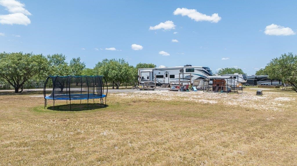 9223 County Road 2249 Sinton, TX 78387 - Photo 20 of 39 a view of swimming pool with outdoor seating and trees in the background
