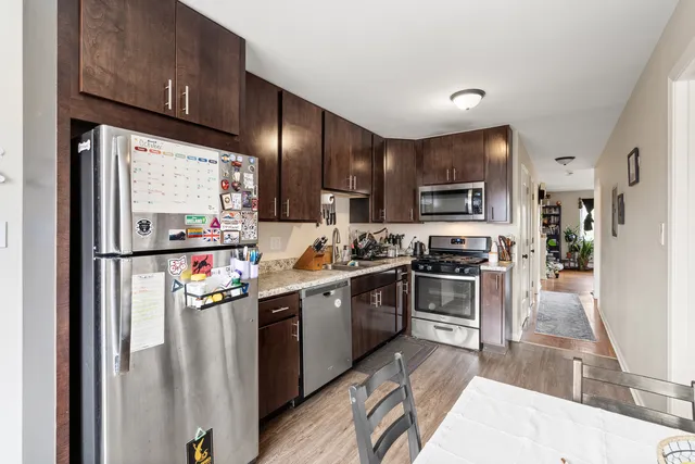a kitchen with stainless steel appliances a sink stove and cabinets