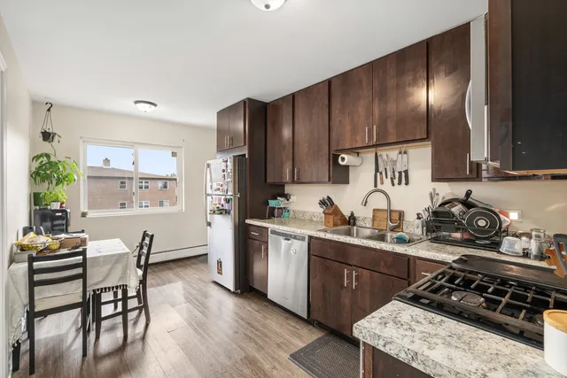 a living room with patio furniture and a potted plant