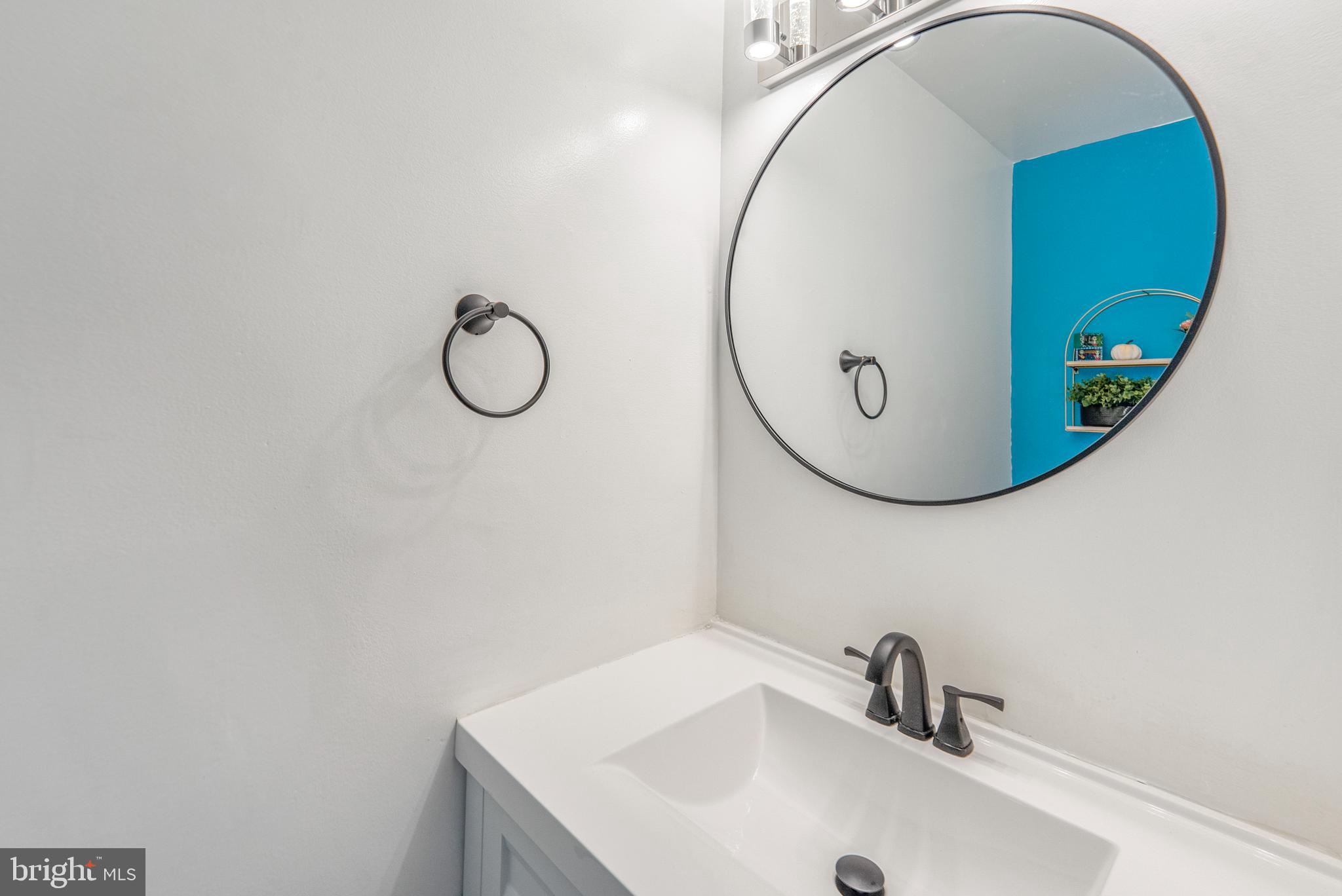 15307 Arbory Way, Unit 6 Laurel, MD 20707 - Photo 13 of 23 a bathroom with a sink and mirror