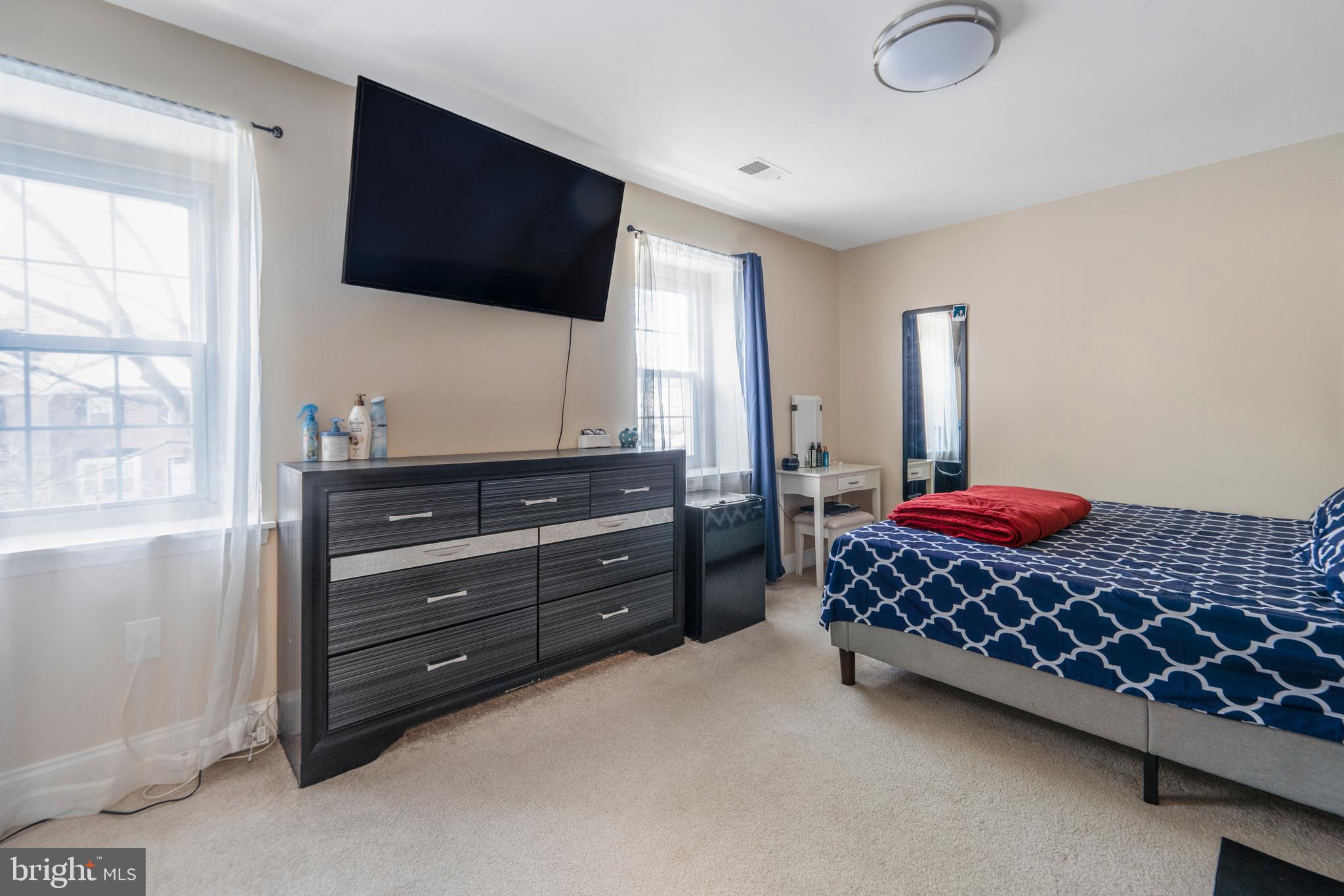 15307 Arbory Way, Unit 6 Laurel, MD 20707 - Photo 18 of 23 a bedroom with a bed and a flat screen tv