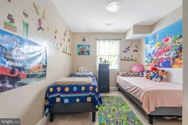 a bedroom with bed and wooden floor