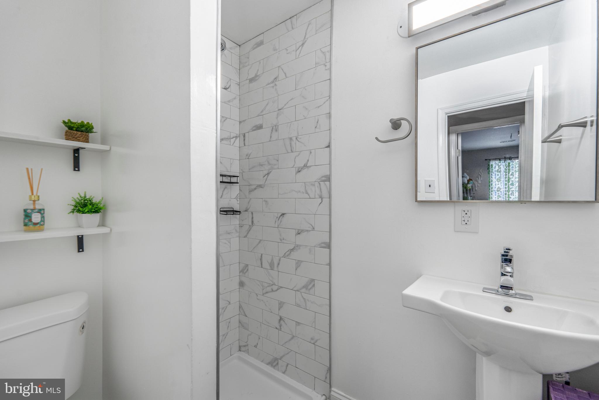 15307 Arbory Way, Unit 6 Laurel, MD 20707 - Photo 22 of 23 a bathroom with a sink a toilet and shower