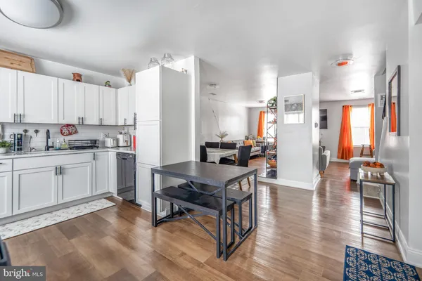 a kitchen with a table chairs refrigerator and cabinets