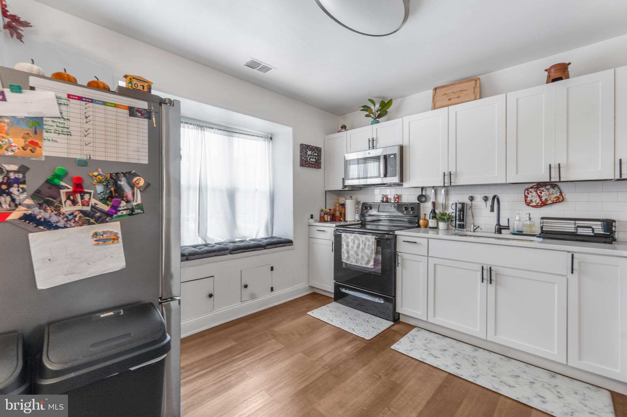 15307 Arbory Way, Unit 6 Laurel, MD 20707 - Photo 4 of 23 a kitchen with white cabinets and window
