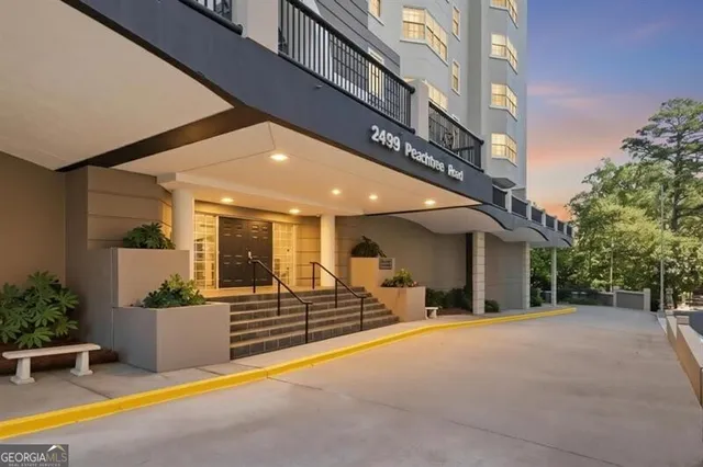 a view of a building with couches in front of house