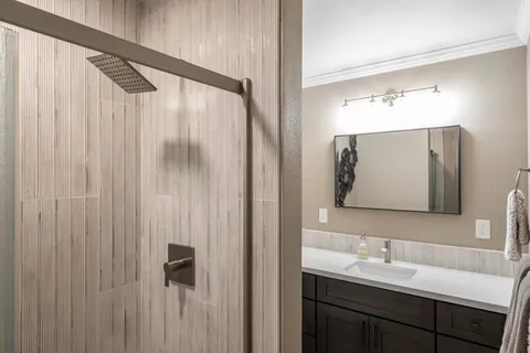 a bathroom with a double vanity sink and mirror