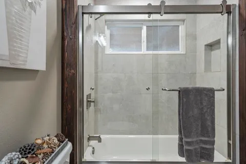 a bathroom with a glass shower door