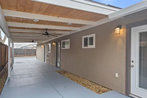 a view of hallway with a ceiling fan