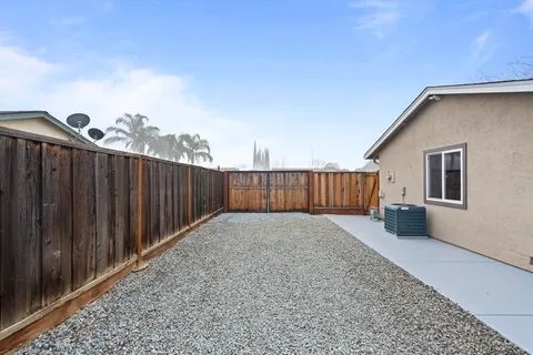 a view of a house with wooden fence