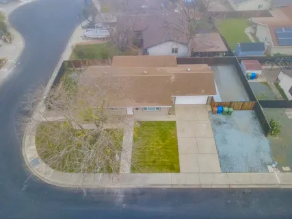 an aerial view of a house with a swimming pool
