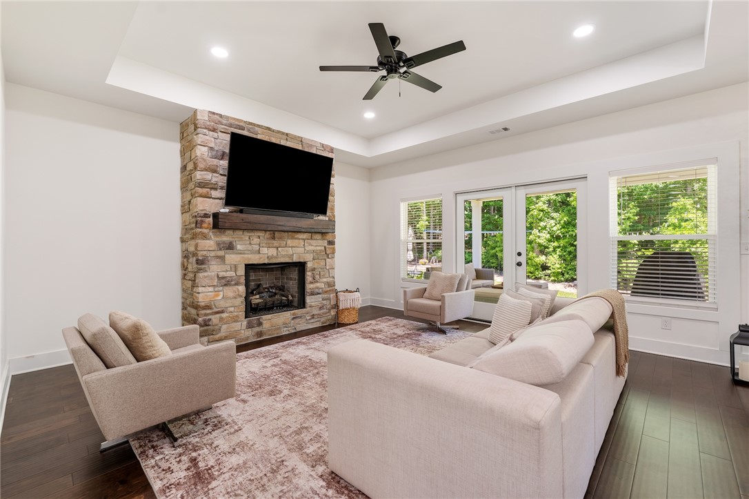 502 Canebrake Drive Anderson, SC 29621 - Photo 5 of 39 This living room features a stately stone fireplace and direct outdoor access, perfect for serene relaxation.