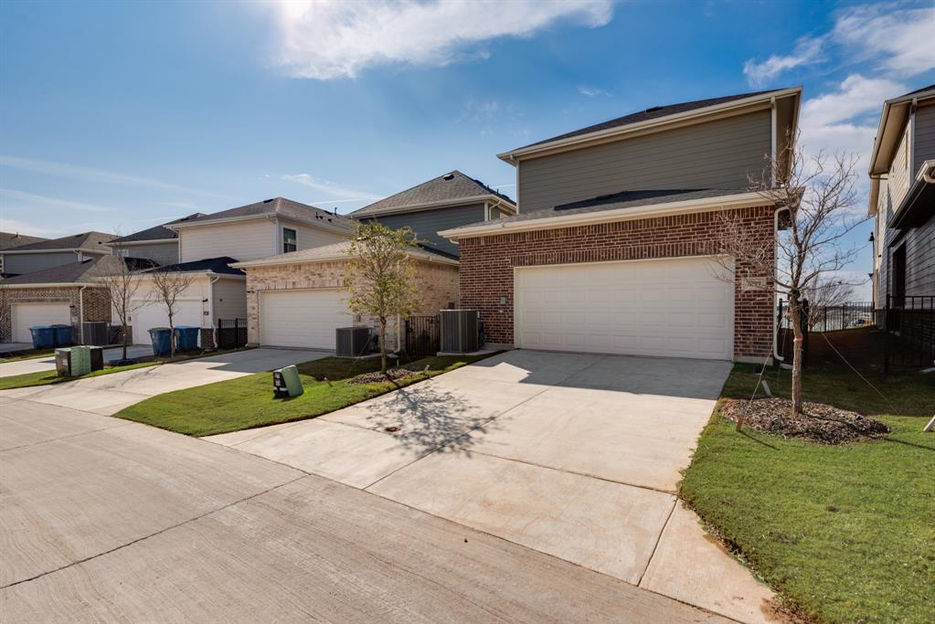 7009 Sunset Boulevard Rowlett, TX 75088 - Photo 3 of 35 a front view of a house with a yard and garage