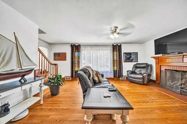 a living room with furniture a fireplace and a flat screen tv
