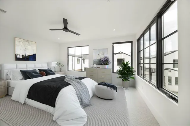 a spacious bedroom with a large bed and a large window