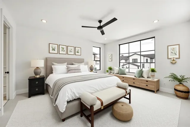 a bedroom with furniture and a large window